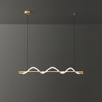 Clérachic linear pendant with a brass bar and three small glowing waves, against a charcoal wall.
