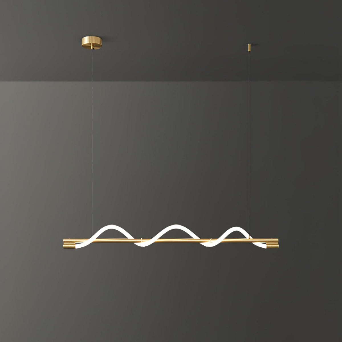 Clérachic linear pendant with a brass bar and three small glowing waves, against a charcoal wall.