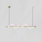 Brass Clérachic linear pendant with two glowing waves, hanging on thin cords against a light grey wall.