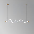 Clérachic brass linear pendant with glowing waves, seen against a mid-grey backdrop.