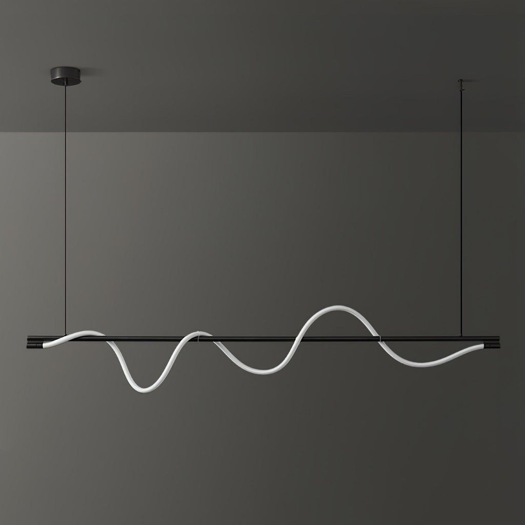 Black Clérachic linear pendant with a white wave that is lit softly, against a dark wall.