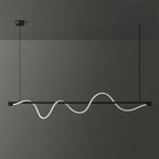 Black Clérachic linear pendant with a white wave that is lit softly, against a dark wall.