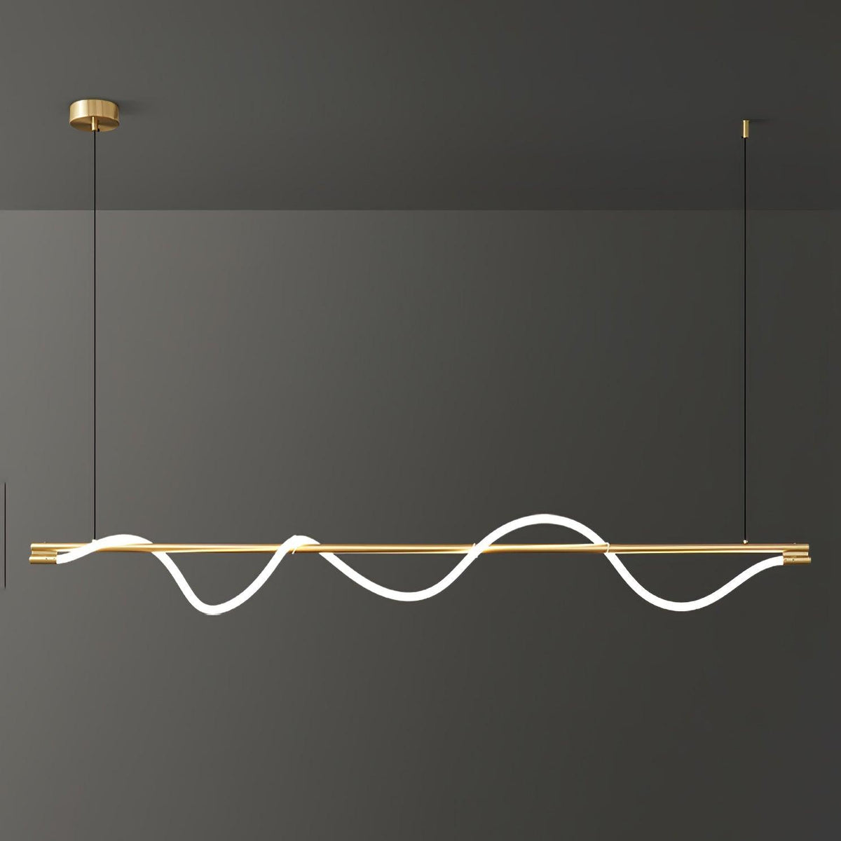 Clérachic linear pendant with a brass bar, a bright wave and a brass canopy, against a dark wall.