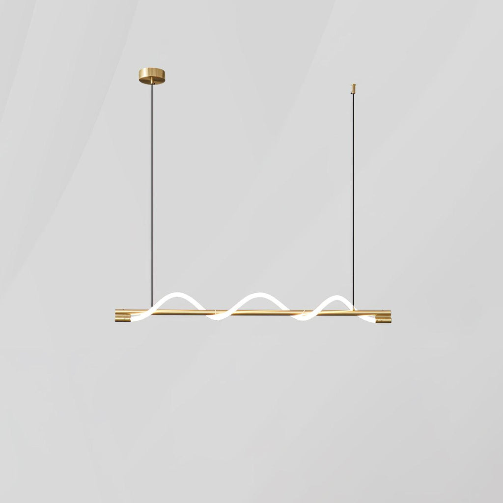 Short brass Clérachic linear pendant with a glowing wave, on a round brass canopy against a pale wall.