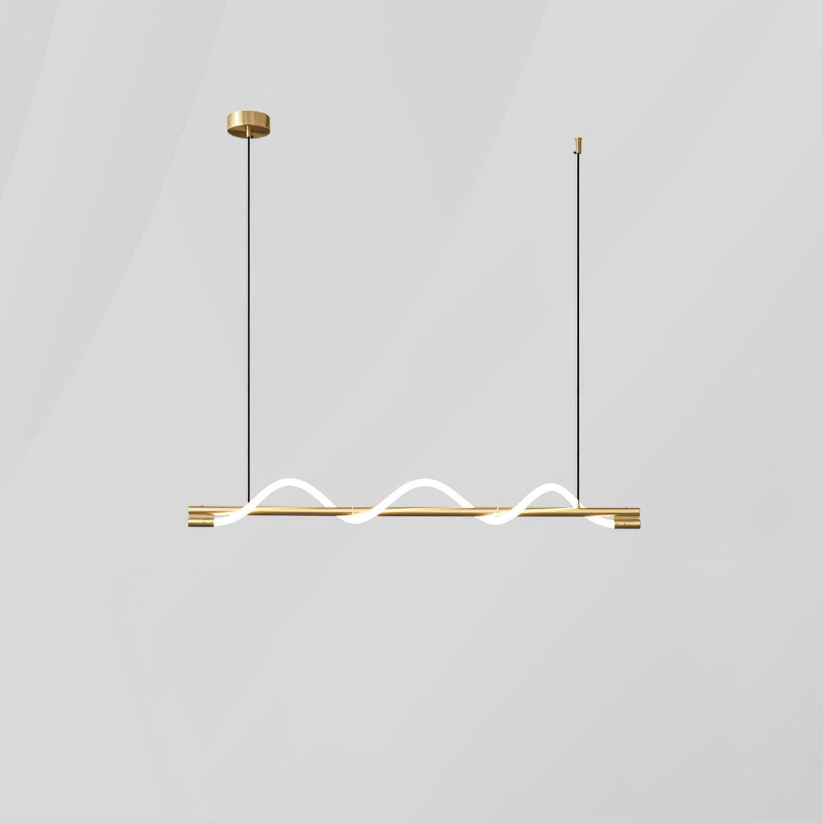 Short brass Clérachic linear pendant with a glowing wave, on a round brass canopy against a pale wall.