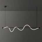 Close-cropped black Clérachic linear pendant with a tall glowing wave, against a dark wall.