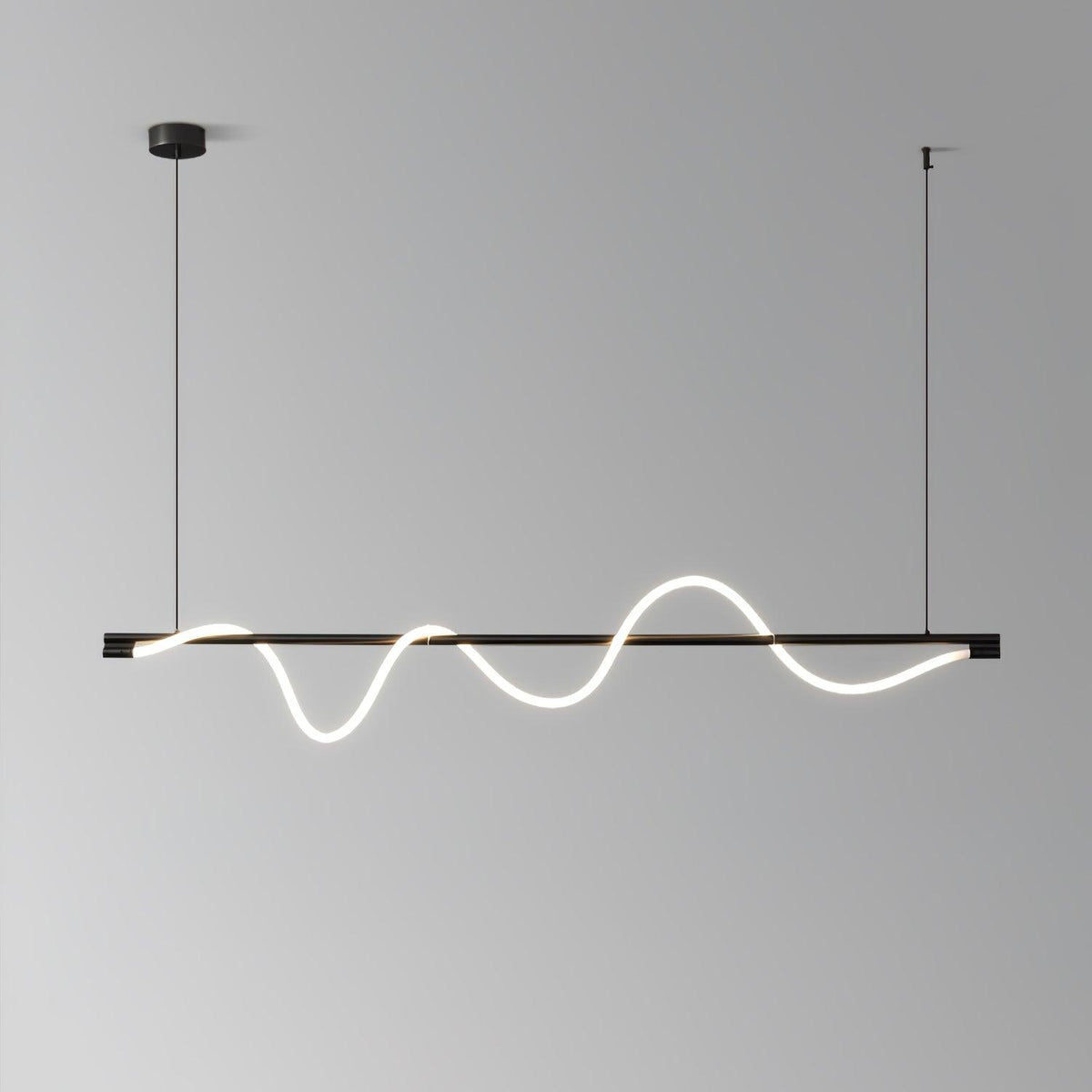 Black Clérachic linear pendant with a deep, glowing wave, in front of a grey gradient wall.