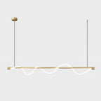Brass Clérachic linear pendant with a glowing wave, a brass canopy and thin cords, on an off-white backdrop.
