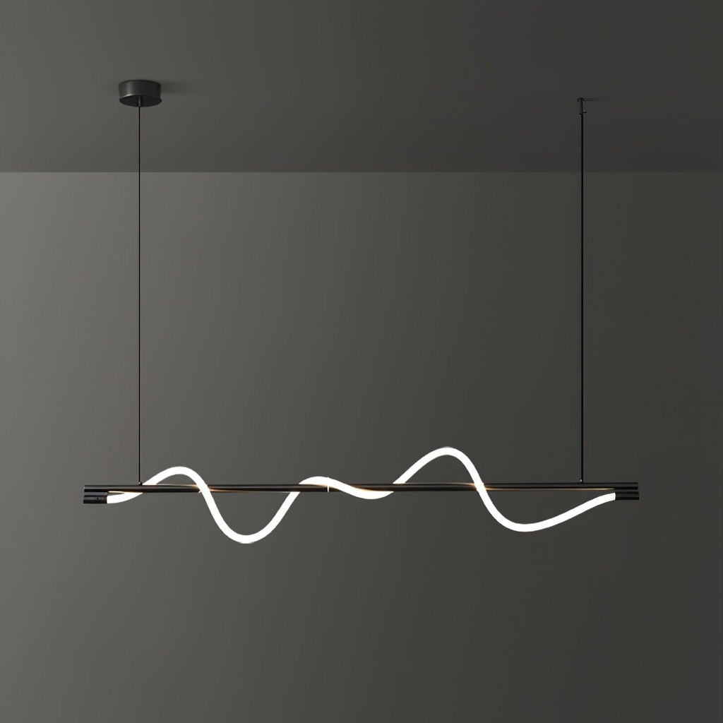 Black Clérachic linear pendant with a tilted glowing wave, seen slightly from the side against a dark wall.