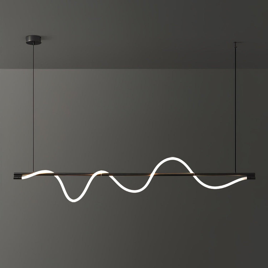 A black Clérachic linear pendant lit with a long, deep wave, hanging in front of a charcoal wall.