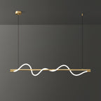 Brass Clérachic linear pendant with a bright wave and a brass canopy, in front of a dark grey wall.