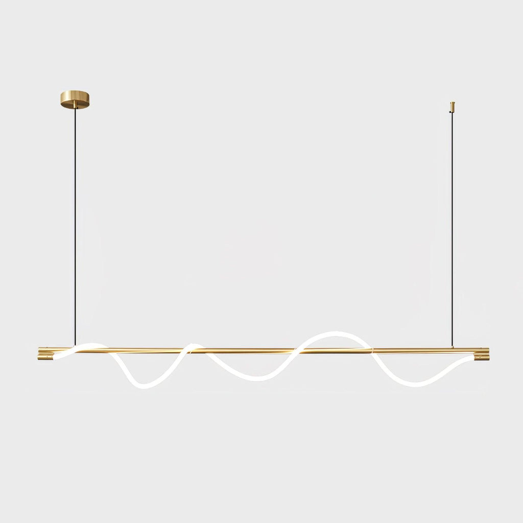 Long brass Clérachic linear pendant with a glowing wave, on a brass canopy against a pale backdrop.