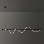 Wide black Clérachic linear pendant with an unlit white silicone wave, against a dark grey wall.