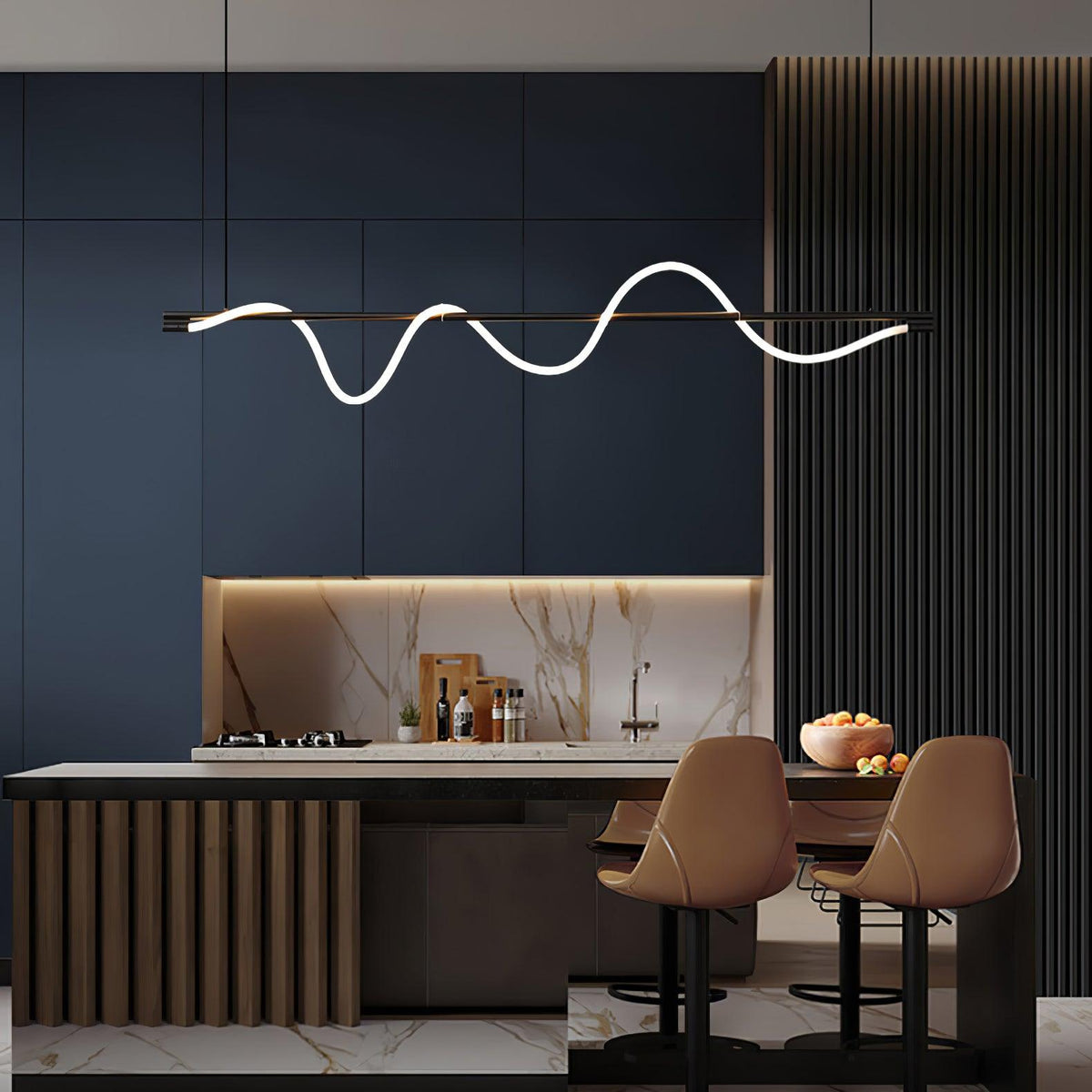 Black Clérachic linear pendant above a kitchen island with tan stools, with navy cabinets and a marble splashback.