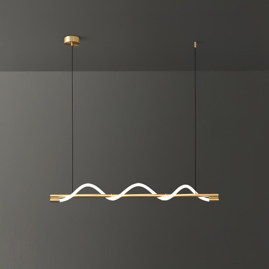 Brass Clérachic linear pendant with three tight glowing waves, against a dark grey wall.