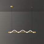 Brass Clérachic linear pendant with three tight glowing waves, against a dark grey wall.