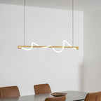 Brass Clérachic linear pendant with a glowing wave, over a table with tan chairs, in a white room.