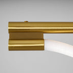 Close view of the brushed brass end cap and the silicone line entering it on this Clérachic pendant.