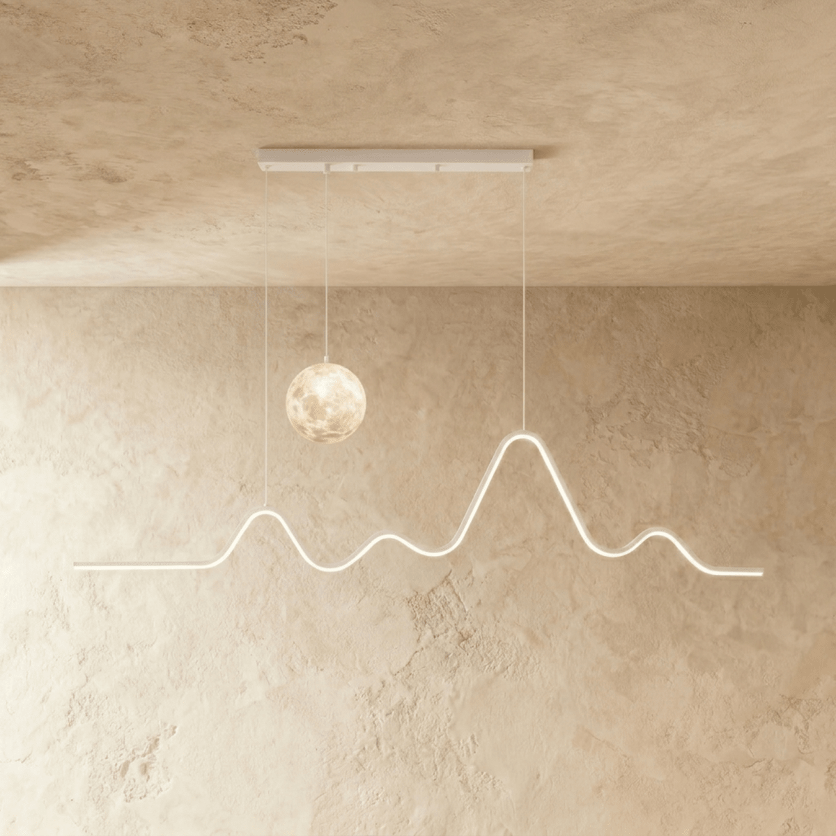 Clérachic 120 cm white pendant with a softly lit moon globe and a glowing mountain-ridge LED line, hung against limewash.