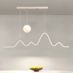 Clérachic 120 cm white pendant with a moon globe and a glowing peak-shaped LED line, hung above a table with a wooden fruit bowl.