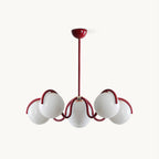 Red Clérachic chandelier on a white backdrop, with six white glass globes held on curving red arms from a slim rod.