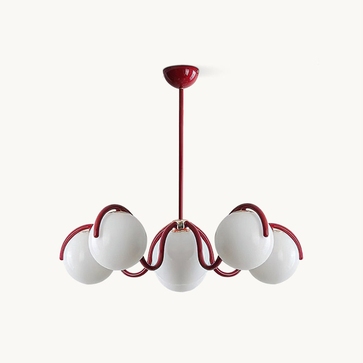 Red Clérachic chandelier on a white backdrop, with six white glass globes held on curving red arms from a slim rod.