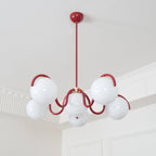 Red Clérachic chandelier with a round canopy and rod, seen from below in a corner with white cornice.