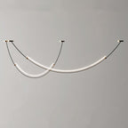Unlit view of this Clérachic pendant against a plain grey wall, black cables running to three canopies with a gold trim.