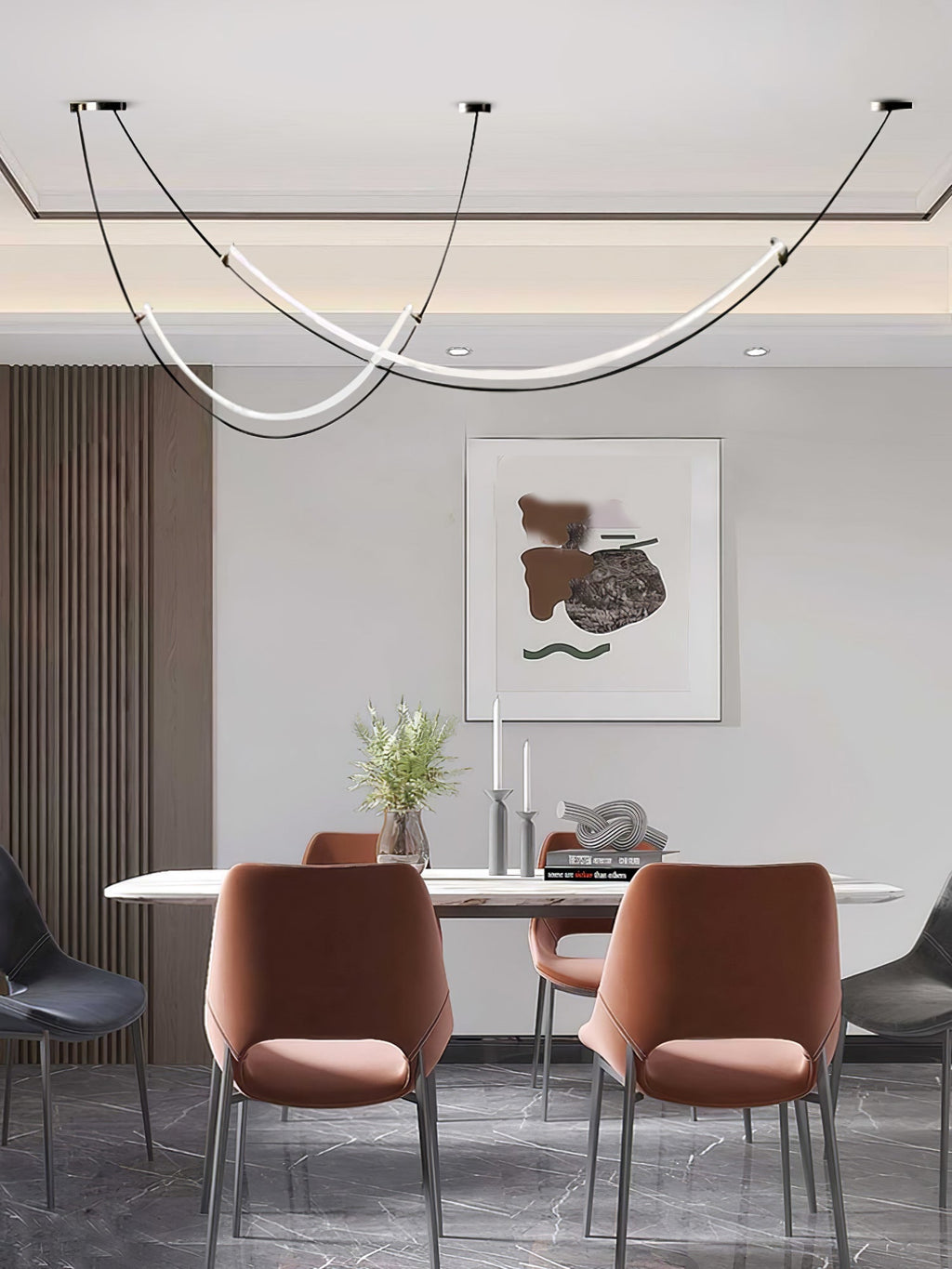 Narrow view of this Clérachic pendant over a white table with rust-orange chairs and an abstract print, in a recessed ceiling bay.