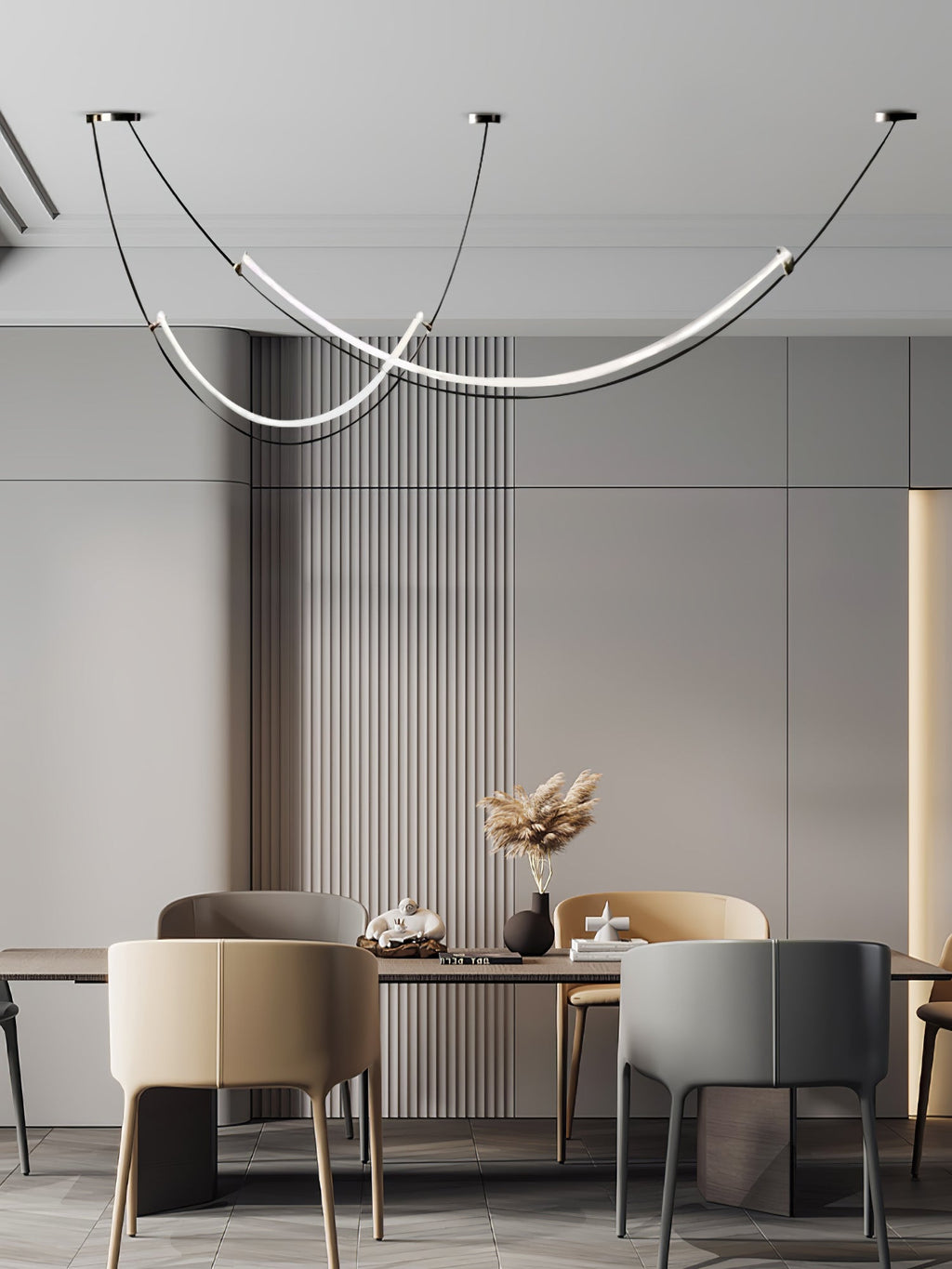Clérachic pendant above a dining table with tan and grey armchairs and dried pampas in a vase, against fluted grey panelling.