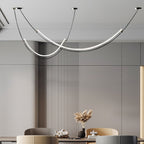 Close crop of this Clérachic pendant over a dining table with dried grasses in a black vase, beside a wall of vertical slats.