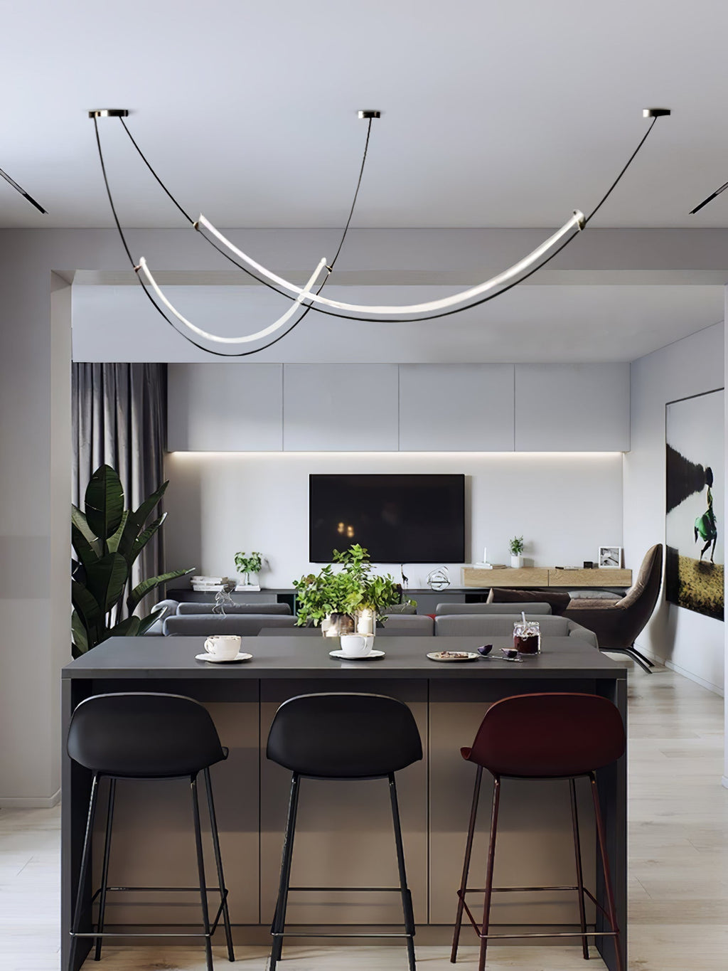 This Clérachic pendant seen from further back, above a dark kitchen island with three bar stools and a living room beyond.