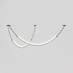 This Clérachic pendant lit against a grey backdrop, shown a little closer than before, with a gold collar at the end of each bar.
