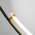 Close view of a brass-coloured fitting where the white LED bar meets the black arm of this Clérachic pendant, lit.