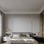 Clérachic ten-reflector recessed downlight in white, centred in a calm grey bedroom ceiling above a bed with green and white linen.