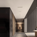 Clérachic white recessed linear downlights running down a dark corridor ceiling towards a lit alcove and slatted walls.