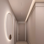 Clérachic white recessed linear downlights set along a narrow hallway ceiling, beside a softly lit round wall mirror and a panelled door.