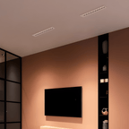 Clérachic two white recessed linear downlights with small reflectors, in a terracotta-toned living room ceiling above a wall-mounted TV.