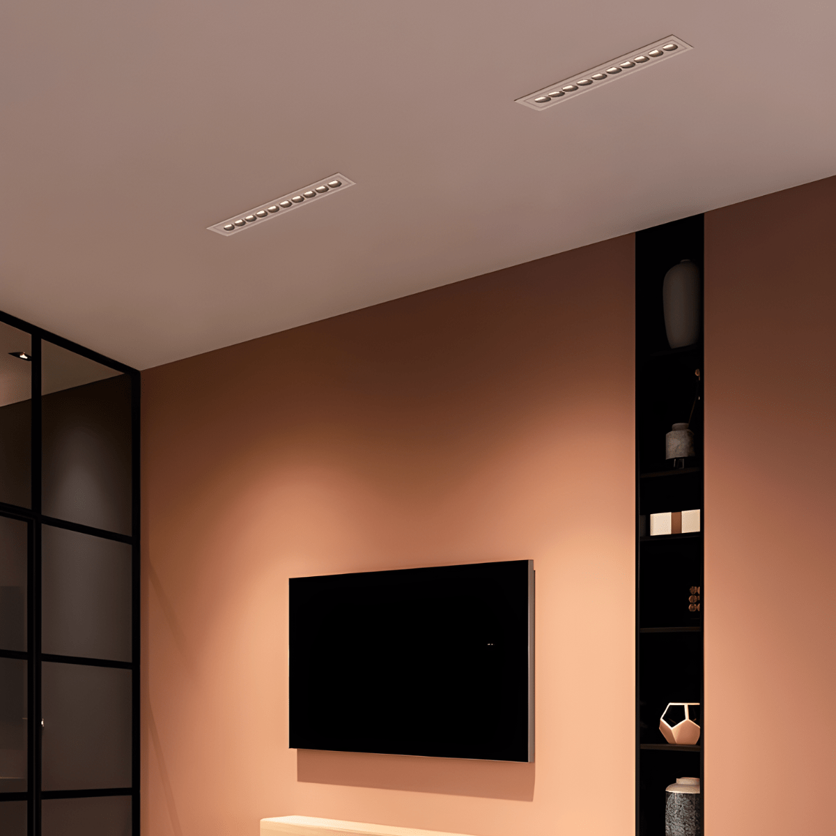 Clérachic two white recessed linear downlights with small reflectors, in a terracotta-toned living room ceiling above a wall-mounted TV.
