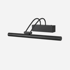 Black version of this Clérachic wall light, with its long round tube, curved double arm and boxy backplate, on a pale backdrop.