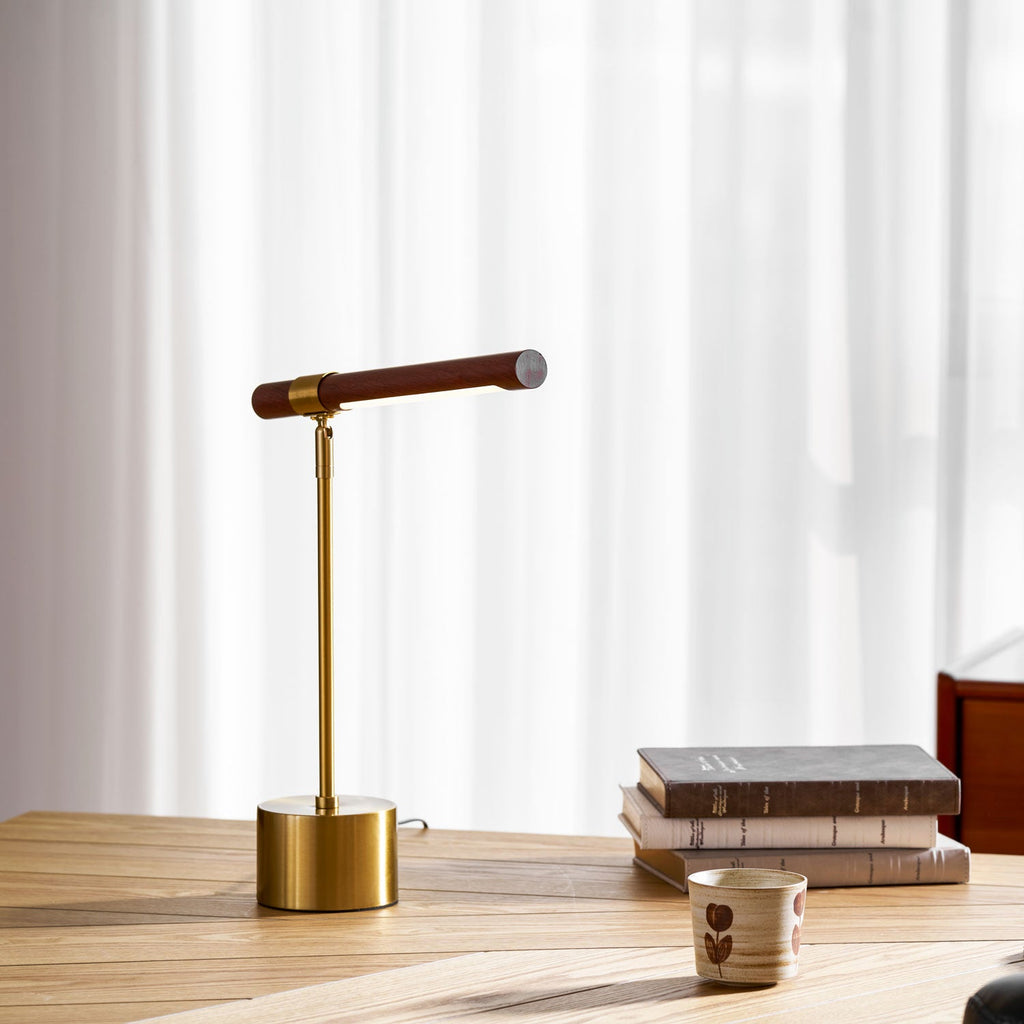 Walnut bar tilted slightly on this Clérachic lamp, standing on a light wood desk beside books and a ceramic cup.