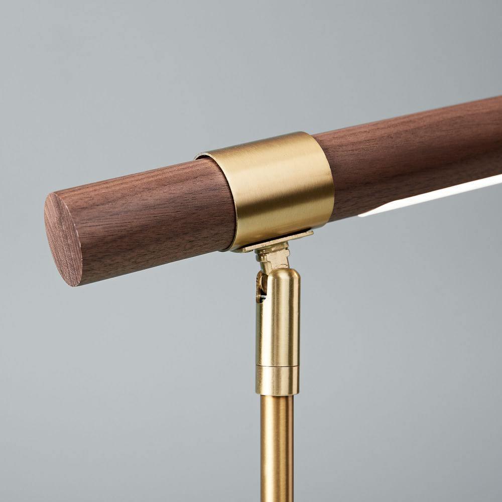 Close view of the brass collar and swivel joint where the walnut bar meets the stem on this Clérachic lamp.
