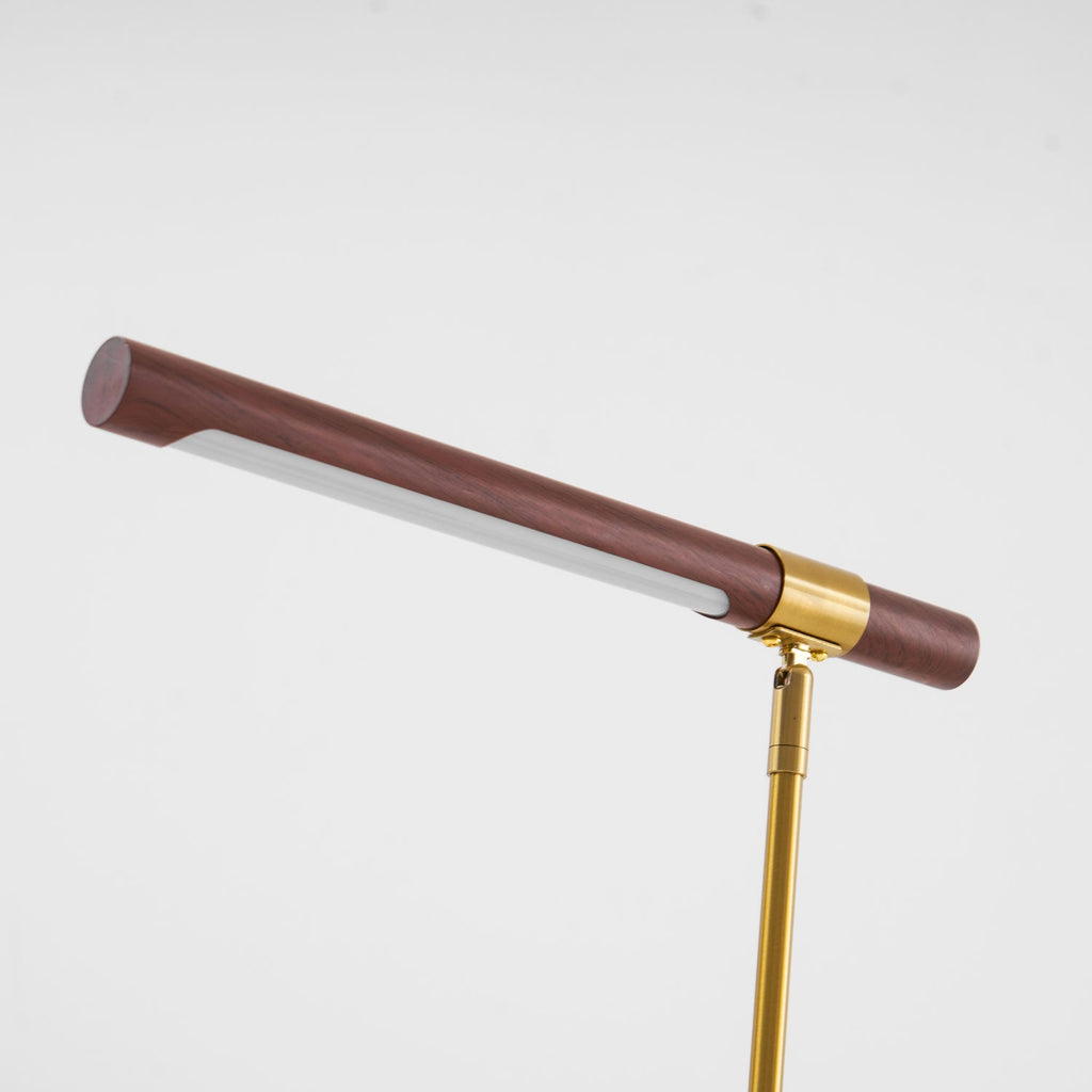Close view of the walnut bar on this Clérachic lamp, tilted up with the white diffuser showing along the underside.