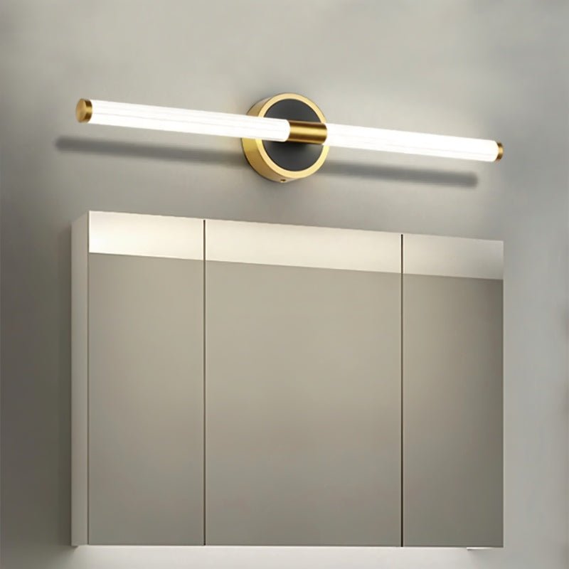 Clérachic LED tube wall light above a mirrored bathroom cabinet, on a round black plate with a brass rim.
