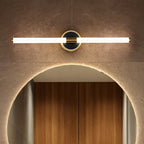 Clérachic LED tube wall light above a backlit arched mirror, on a round black plate with a thin brass rim.