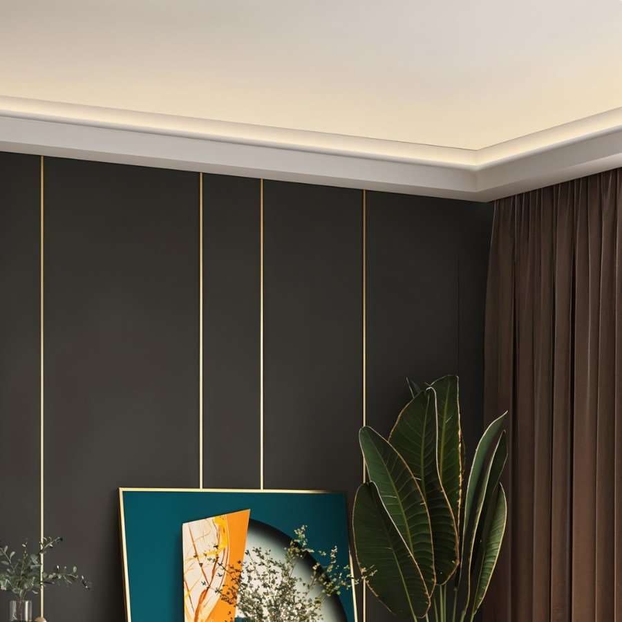 Clérachic white profile light tracing a ceiling edge above dark panelled walls, giving the room a soft warm glow.