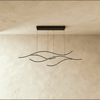 Clérachic black four-arc wavy LED pendant seen straight on, its thin cables falling from a long black ceiling plate.