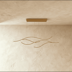 Clérachic gold four-arc wavy LED pendant, shown switched off, with fine cables and a matching gold ceiling plate.