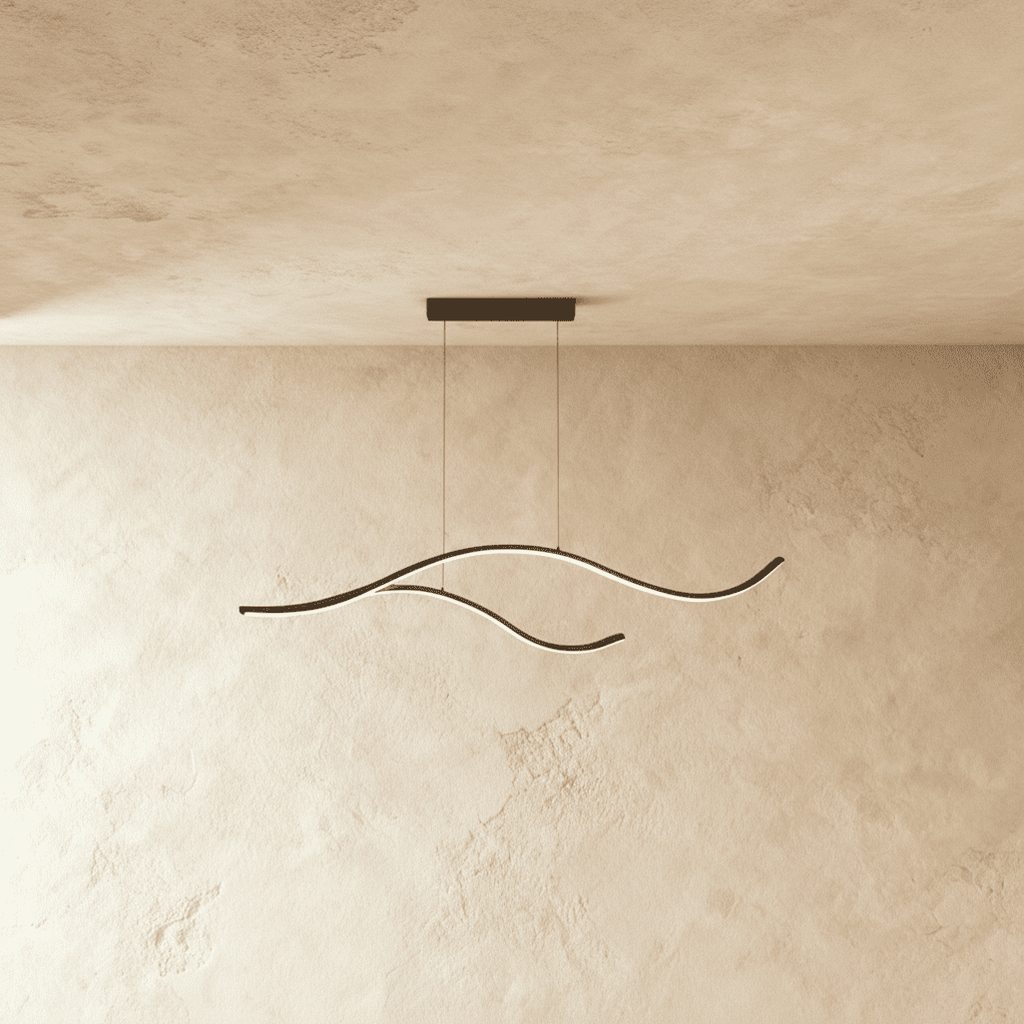 Clérachic black two-arc wavy LED pendant on twin cables, its slim silicone-lit curves glowing softly against a limewash wall.
