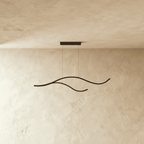 Clérachic black two-arc wavy LED pendant shown switched off, a pair of slim aluminium curves hung from a small black canopy.